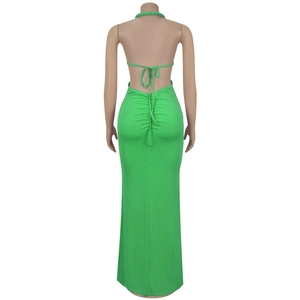 Macro shot of back ruching and halter neck tie on bright green knitted maxi dress
