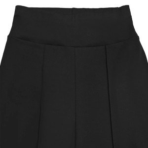 Detail of high-waist black trousers featuring decorative pleats and elastic waistband