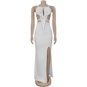 Detail of white knit halter dress featuring waist cutouts and woven floral pattern