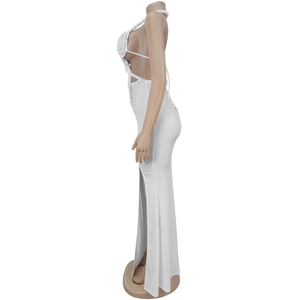 Detail of white halter neck dress featuring side high slit and textured knitted fabric