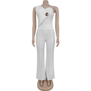 Detail of white one-shoulder top with gold metal buckle and wide-leg high waist trousers