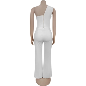 Rear view of white two-piece set featuring a one-shoulder top and high-waisted flare trousers