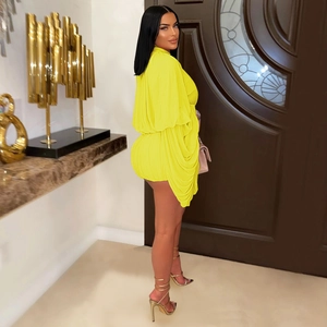 Detail of bright yellow pleated fabric and long sleeve cuff on this slim fit dress