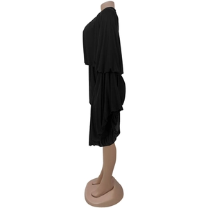 Detail view of black loose-fit dress featuring layered bell sleeves and fluid fabric drape