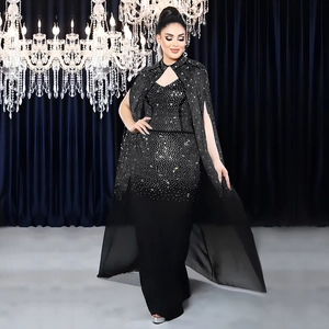 Robe moulante noire élégante avec strass argentés et cape longue sur fond luxueux