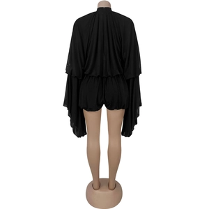 Back view of a black romper with oversized cape-style split sleeves and elastic waist