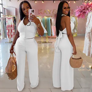 Women's black two-piece set featuring a halter button vest and high waist wide-leg trousers