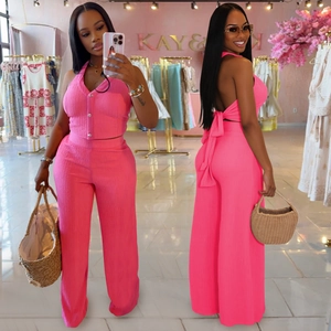 Women's two-piece rose pink ribbed set featuring halter neck top and wide leg pants