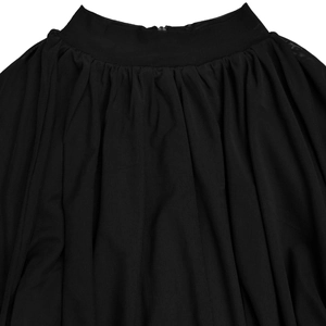 Detail of waist gathers and mesh fabric texture on this black pleated romper for women
