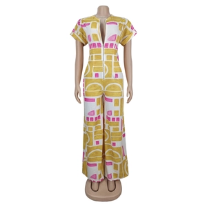 Detail of summer jumpsuit featuring abstract yellow print and metal front zipper
