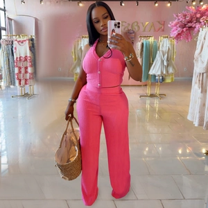 Detail of hot pink halter top and wide-leg pants set with ribbed knit texture