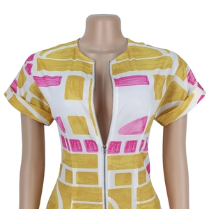 Detail of female jumpsuit showing front metal zipper and abstract geometric pattern print