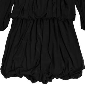 Detailed macro view showing the fine ruched texture and pleats of the black romper fabric