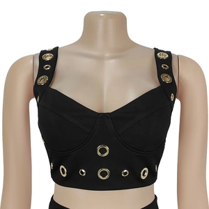 Detail eines schwarzen Crop-Tops mit Herzausschnitt und goldenen Ösen an den Schulterträgern