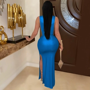 Back view of elegant royal blue evening gown featuring high neck, open back and side slit