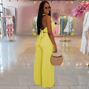 Detail of bright yellow halter top with back bow tie and ribbed texture fabric