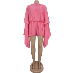 Detail of pink pleated romper featuring oversized batwing sleeves and elastic waist