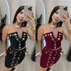 Detailed view of the gold eyelet hardware on the sexy black and burgundy mini skirt sets