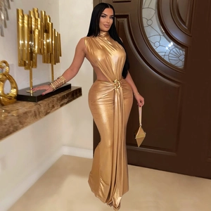 Detail of elegant gold evening gown featuring waist cut-out with metallic ring buckle