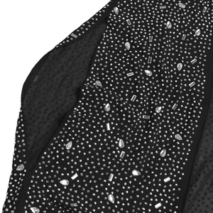 Vue macro détaillée de strass argentés étincelants sur tissu mesh noir pour robe de soirée