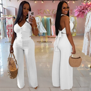 Detailed view of white ribbed knit set with button-up vest and wide-leg trousers