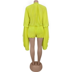 Detail of neon yellow two-piece set featuring flared sleeves and a high neck stand collar