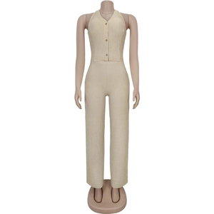 Detailed view of the textured beige fabric on halter vest and high-waisted trousers set