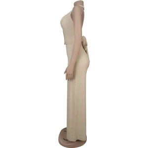 Detail of beige halter top and pleated skirt set showing fine vertical texture