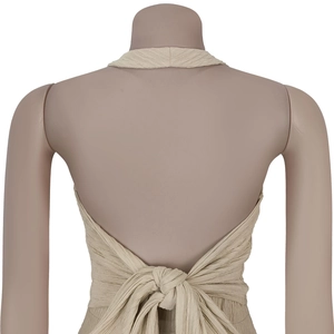 Close-up of the elegant backless halter top with chic tie-up bow detail in beige crepe