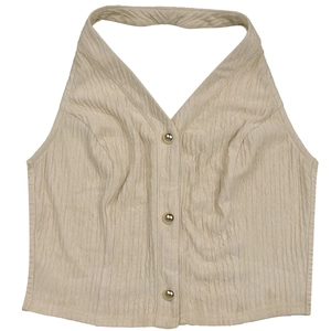 Detail of beige halter top featuring pleated fabric texture and gold buttons on front