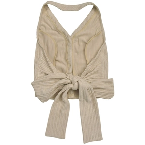 Close-up of beige halter top featuring textured crepe fabric and a large back bow tie