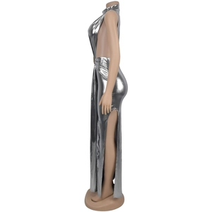 Detail of silver metallic sleeveless halter dress featuring high slit and open back