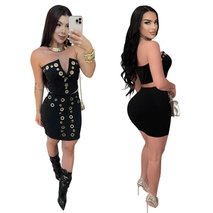 Detail view of black two-piece set featuring gold metal eyelet studs on tube top and skirt