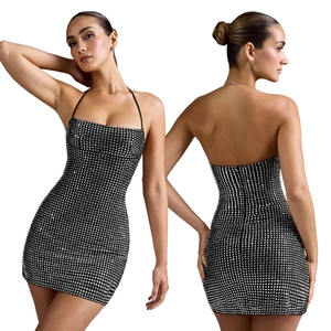 Detail view of sparkly halter neck dress with silver rhinestones on black stretch fabric