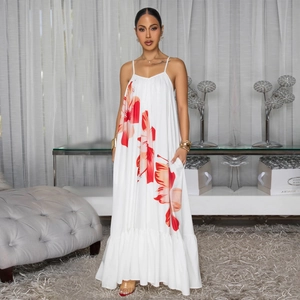 Women's white spaghetti strap maxi dress with bold red floral print and ruffled hemline
