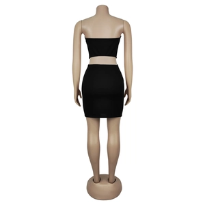 Back view of a chic black two-piece set featuring a tube top and slim mini skirt