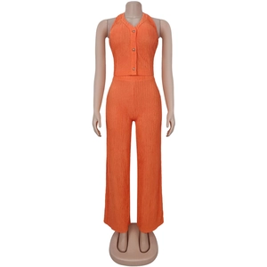 Detail of orange two-piece set with halter neck top and textured wide-leg pants