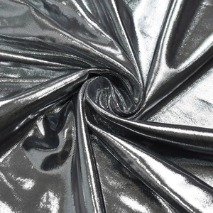 Macro detail of elegant silver metallic fabric with high-shine texture and spiral folds