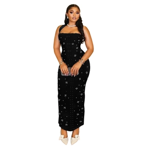 Detail of black halter corset maxi dress with crystal star embellishments and pearls