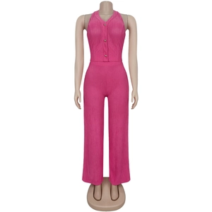 Detail of peach pink pleated fabric texture on halter top and high waist trousers set