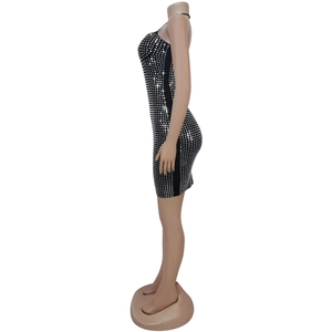 Close-up of black bodycon mini dress with shimmering silver rhinestone grid pattern