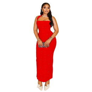 Detail view of red sleeveless halter dress with dense pearl beadwork and textured finish