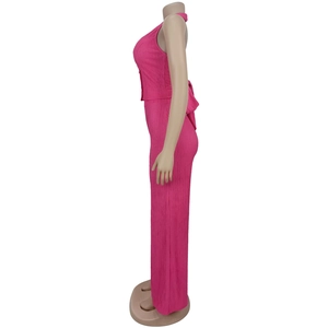 Detail of rose pink pleated fabric showing halter top bow tie and high waist pants