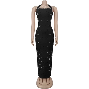 Detail of black halter dress featuring sparkling rhinestones and elegant faux pearl beads