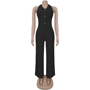 Detail of black halter v-neck top with gold buttons and vertical ribbed fabric texture