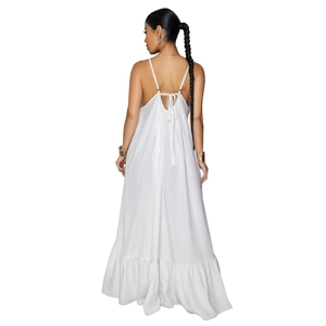 Detail of white floral sundress featuring a backless design with a bow tie and ruffle hem