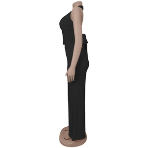 Detail of the black halter neck top with bow tie back and pleated fabric texture