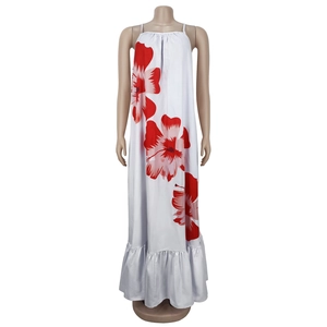 Detailed close-up of white floral maxi dress with red hibiscus print and ruffle hemline
