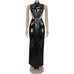 Detail of elegant black glossy maxi dress with gold heart-shaped buckle and waist cutout