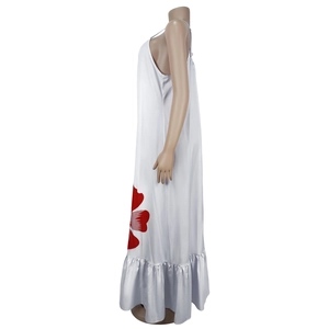 Detail view of white satin maxi dress with red floral print and ruffled hemline